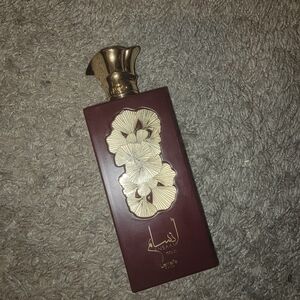 Oud-Inspired Fragrance Bottle in Deep Burgundy with Gold Accents